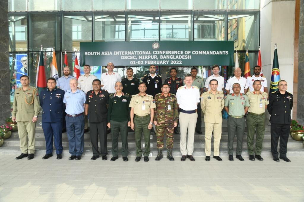International delegates stood outside the Defence Services Command and Staff College, Bangladeshsurrounded by national flags of those in attendance. 