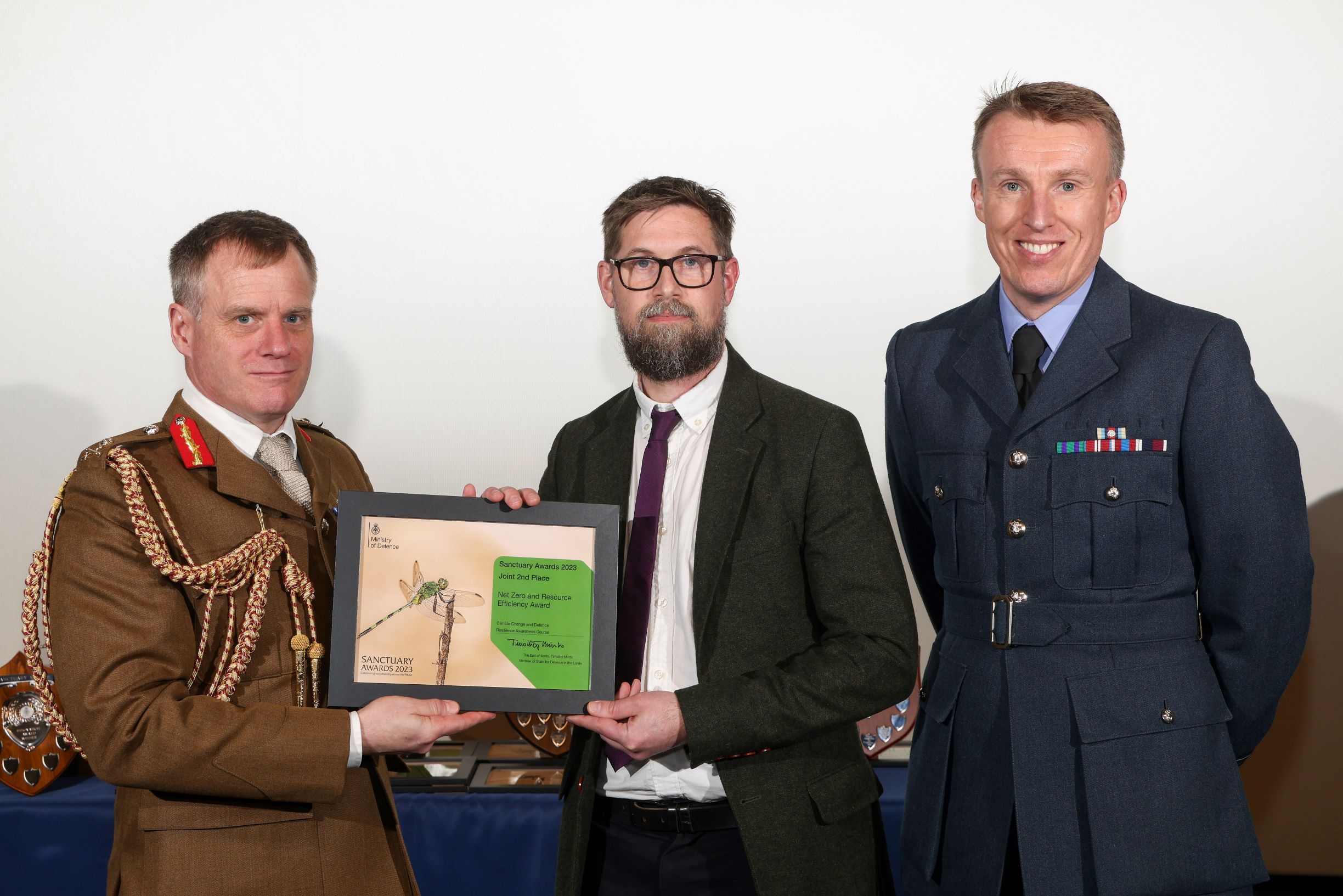 Army officer, civil servant and RAF officer holding Sanctuary Awards Net Zero certificate.