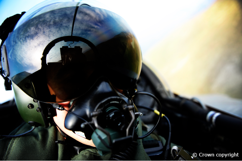 An RAF pilot sat inside a Tornado GR4 aircraft wearing a helmet and mask.