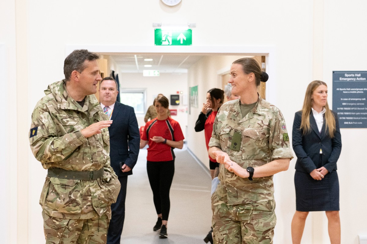 Heather Stanning talking to Maj Gen Roe as they tour the Sports Hall.