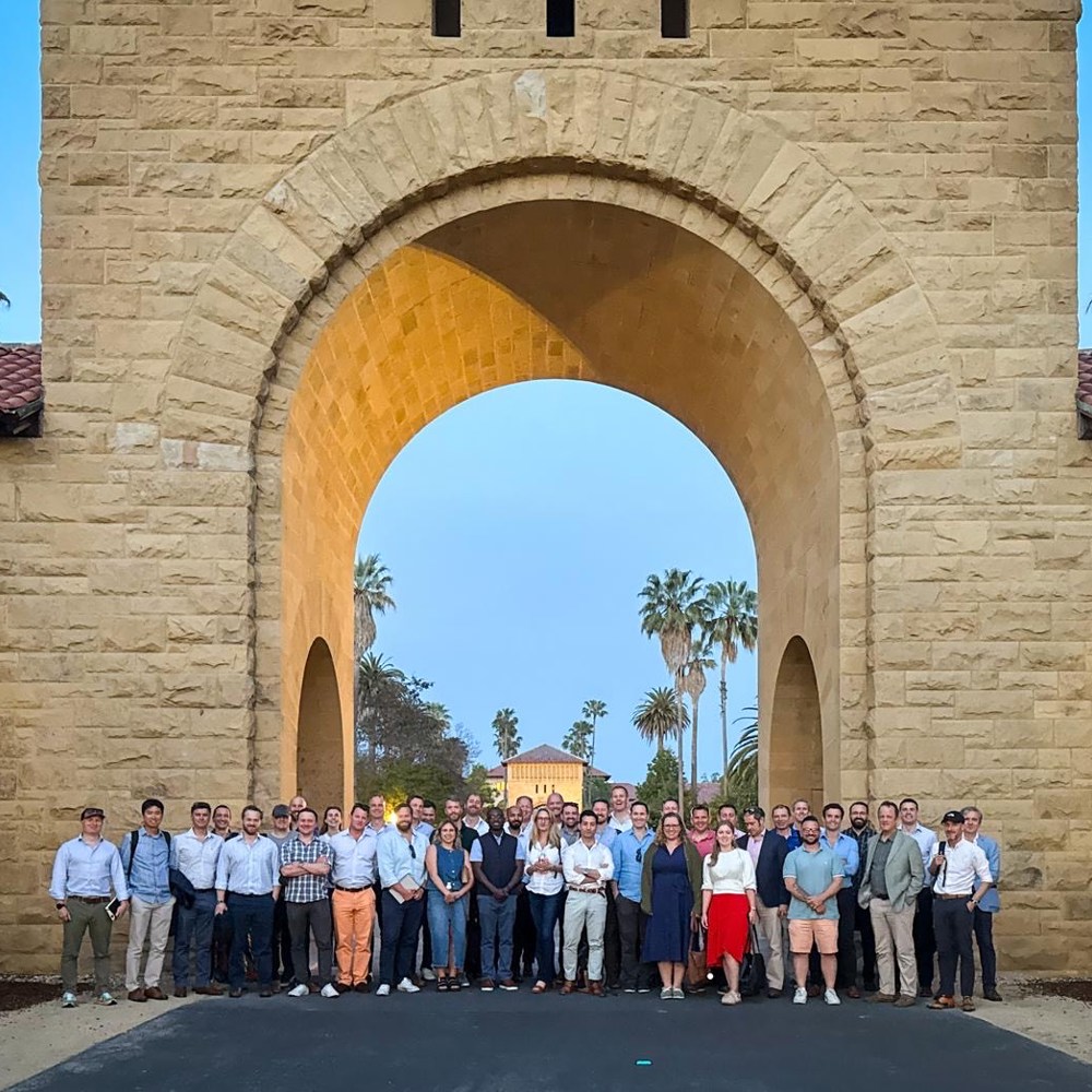Course members outside under a stone arch in San Francisco.