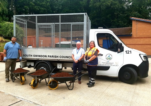 A crew stood in front of a Swindon parish van with compost in wheelbarrows.