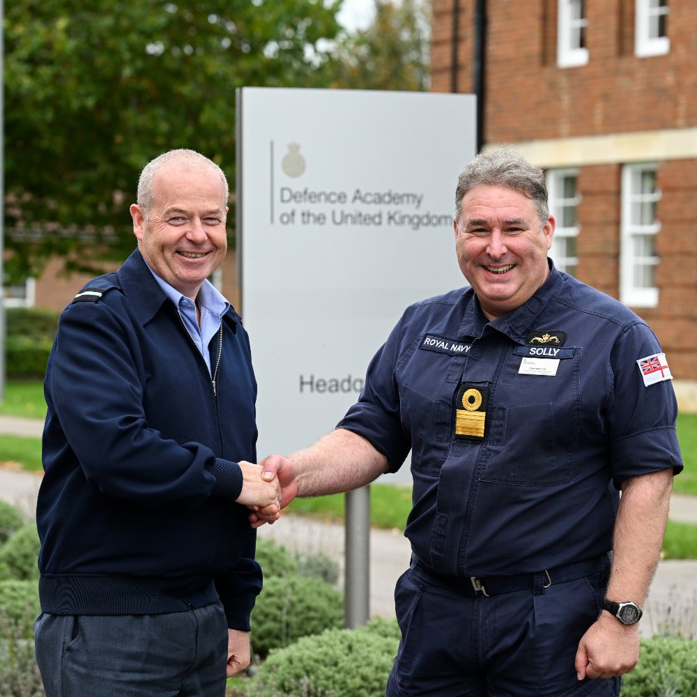 An RAF and Navy officer shaking hands.