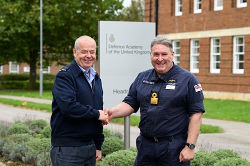 An RAF and Navy officer shaking hands.