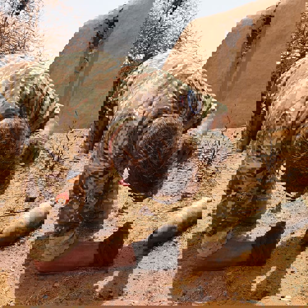 An Army officer led on ground checking weapon shell.