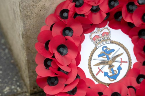 Close up of poppy wreath with Defence Academy crest in the centre.
