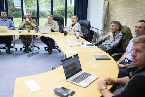 DLC colleagues sat in a horseshoe seating order.