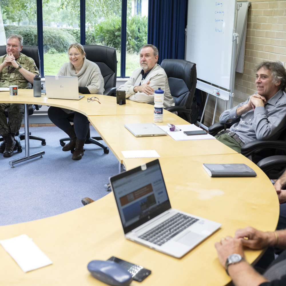 DLC colleagues sat in a horseshoe seating order.