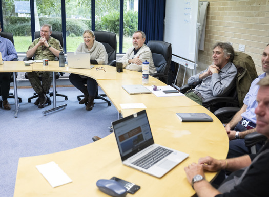 DLC colleagues sat in a horseshoe seating order.