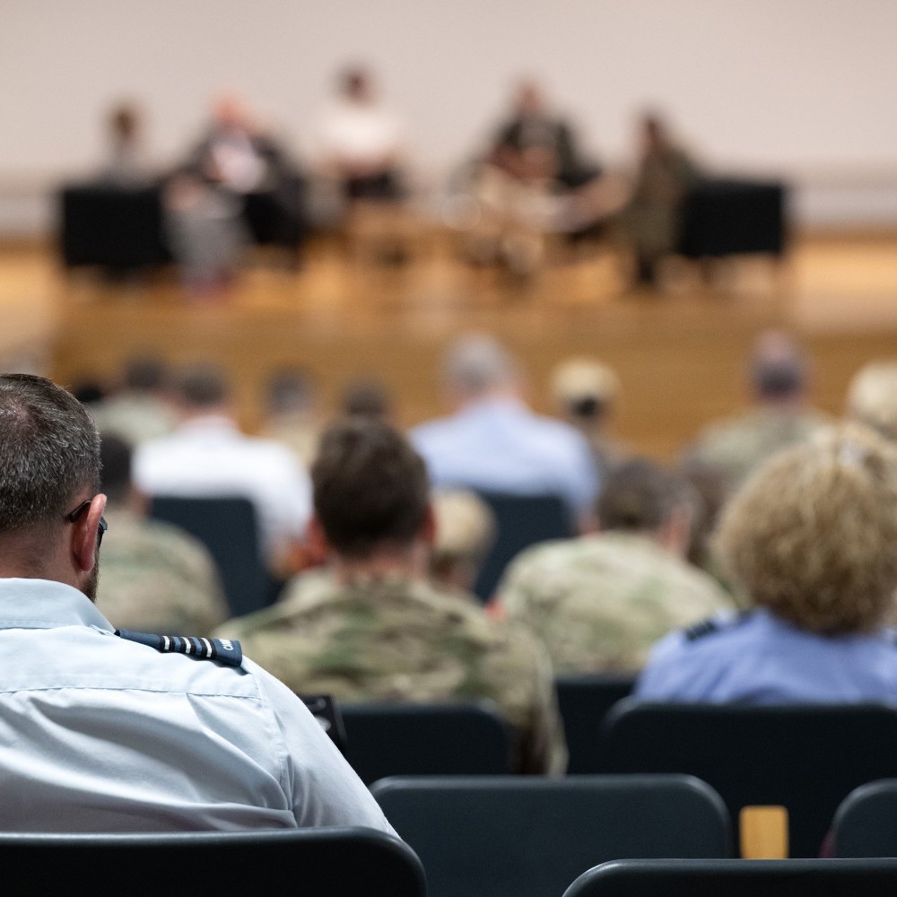 Back of military officer audience observing a presentation.