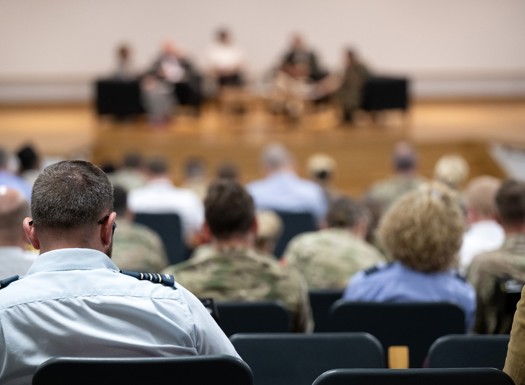 Back of military officer audience observing a presentation.