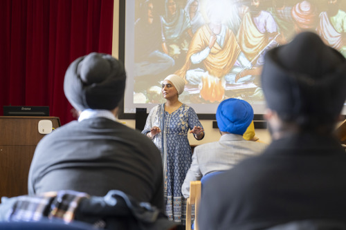 Sikh serving personnel in a classroom listening to a lecturer