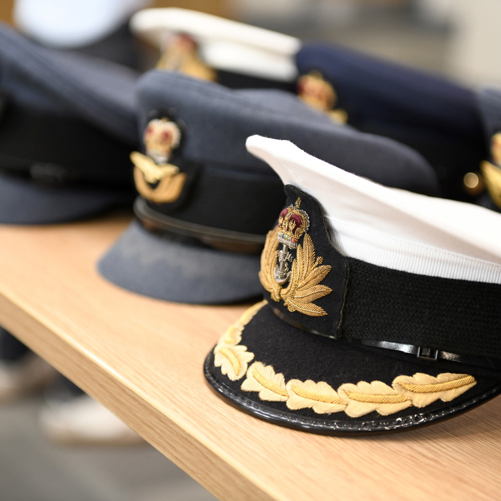 A selection of Royal Air Force uniform caps aligned in a row on a table