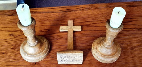 A crucifix and candlestick in a museum display.