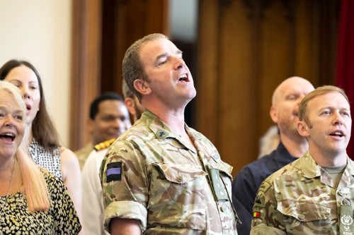 Male army officer singing.
