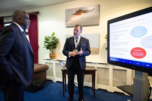 Lord Sewell being shown a presentation on a C-Touch screen.
