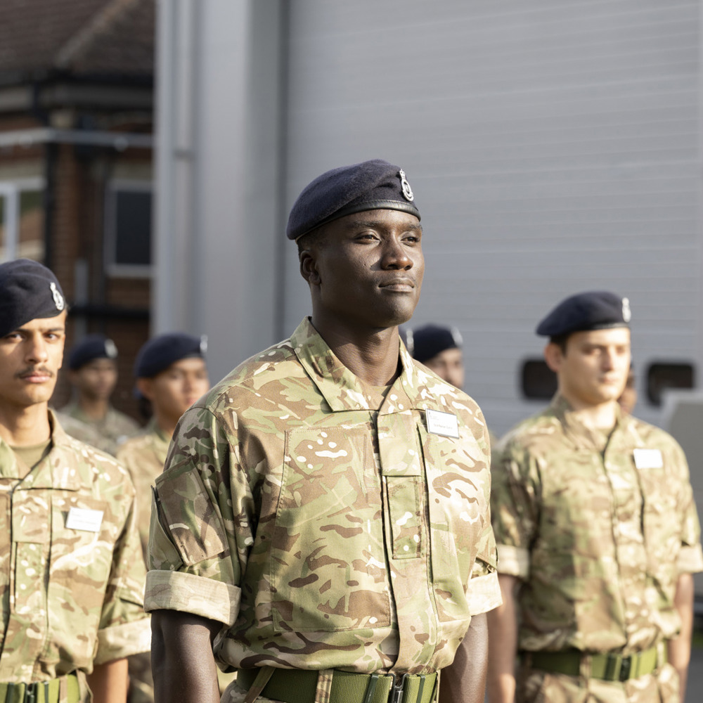 Pre-RMAS international students saluting during parade.