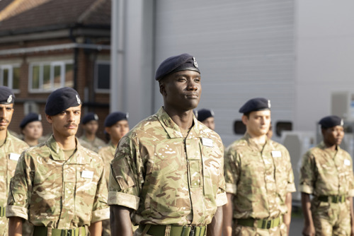 Pre-RMAS international students saluting during parade.