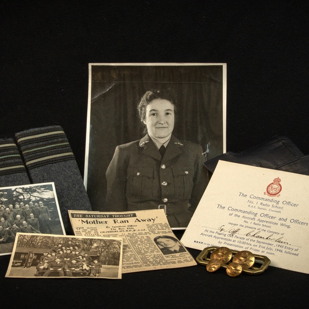 Black and white portrait of a soldier in uniform surrounded by military memorabilia including gloves, RAF epaulettes, medals, and old photographs.