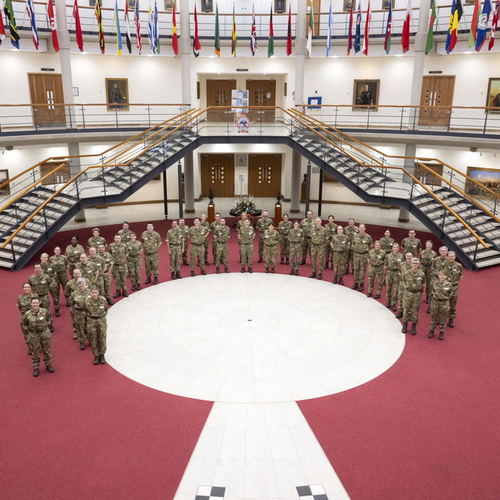 A semi circle of people in military MTP's.