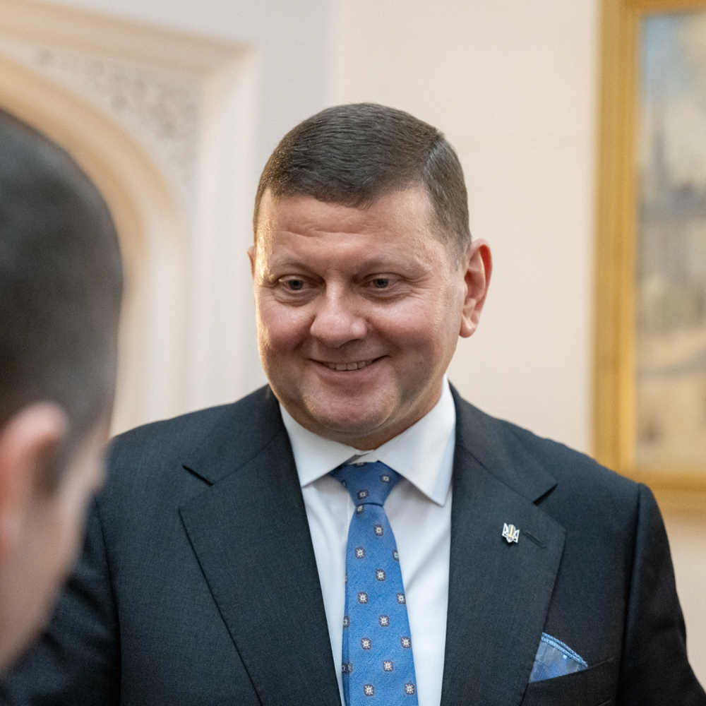 Ukrainian ambassador in suit smiling.