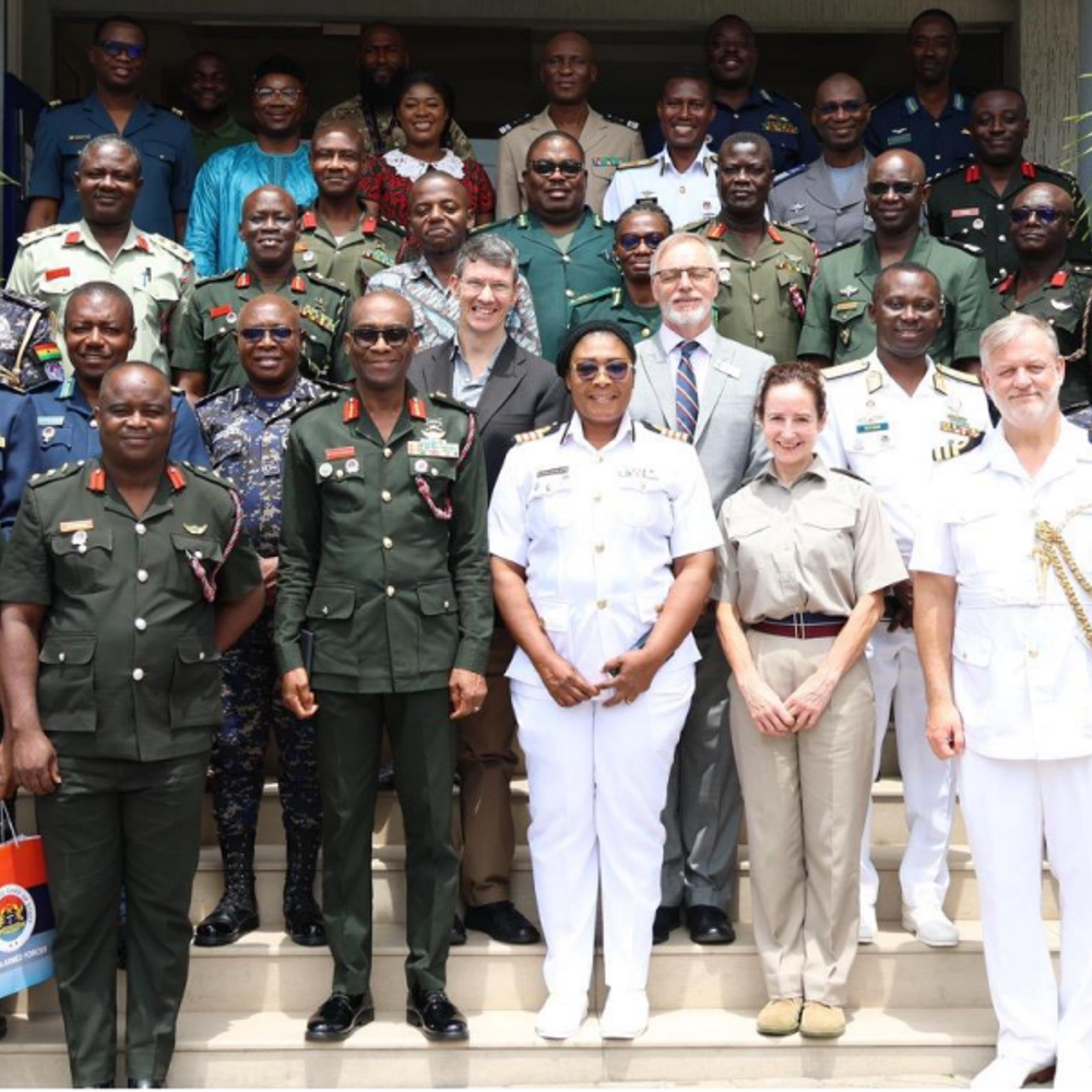 International military officers stood in a group shot in their uniforms.