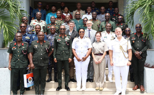 International military officers stood in a group shot in their uniforms.