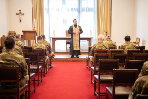Ukrainian chaplain stood at the altar of a chaplain leading morning prayers. 