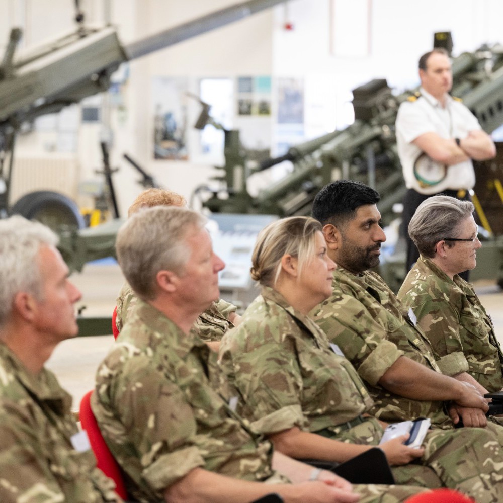 A group of AFPS members sat in a row listening to a talk. 