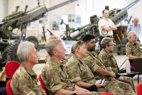A group of AFPS members sat in a row listening to a talk. 