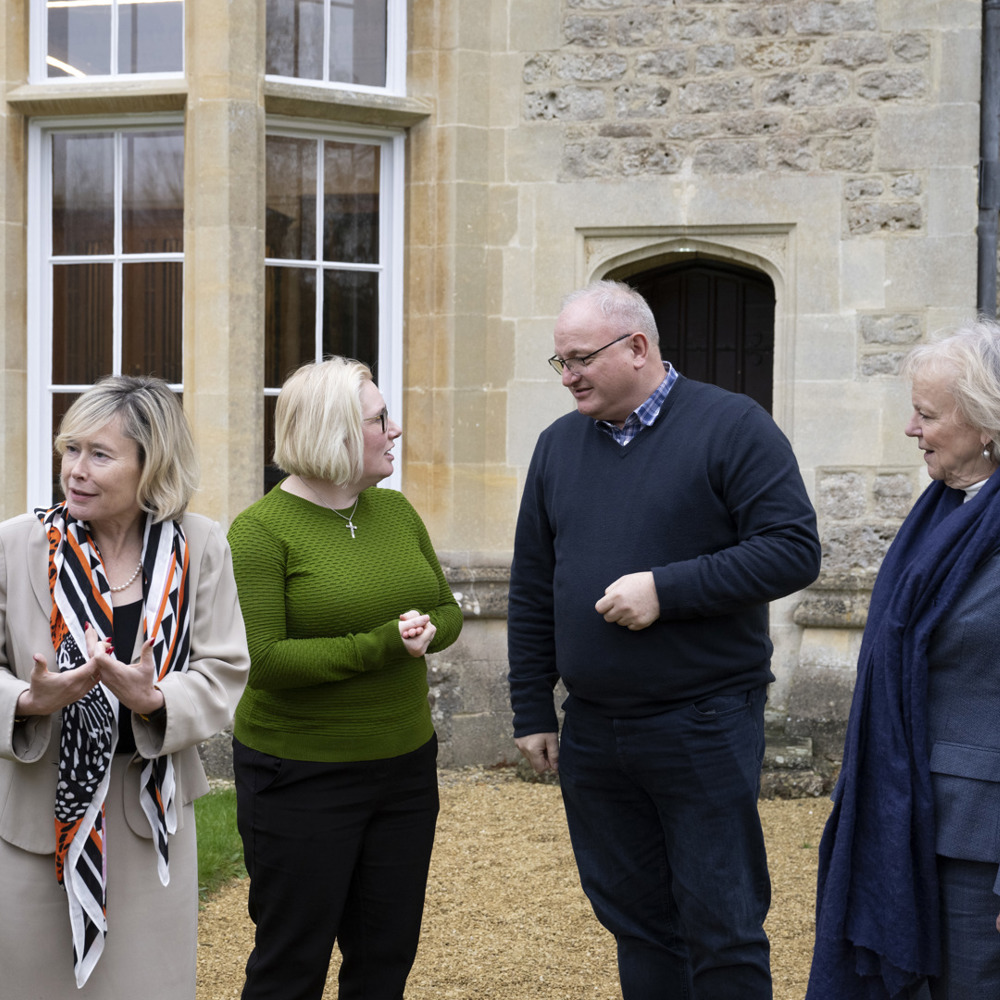 Peers and MPs having a group discussion outside Beckett House