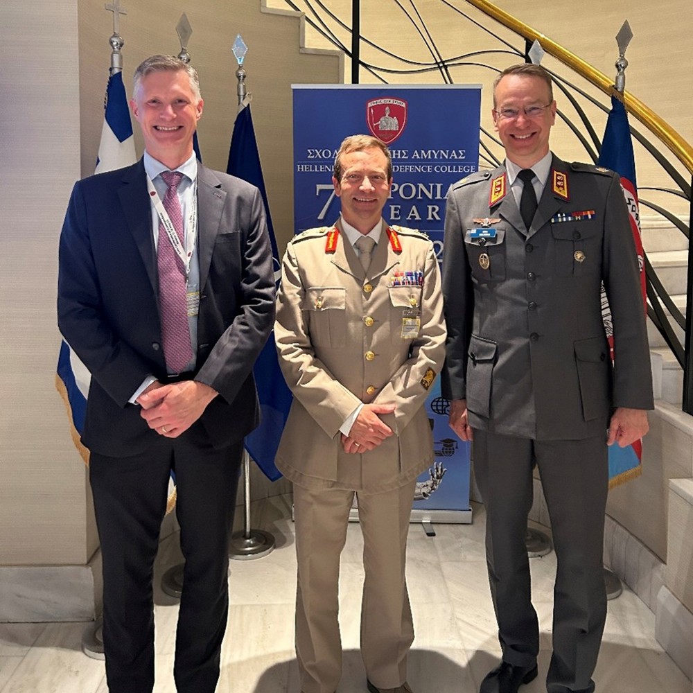 Swedish, British and Finish military officers stood at a NATO conference.