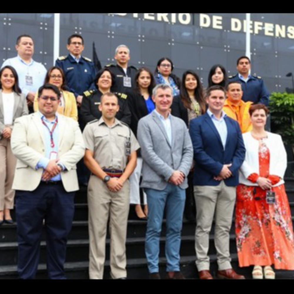 A group of BUIK and course trainers stood on steps outside Peruvian defence staff college. 