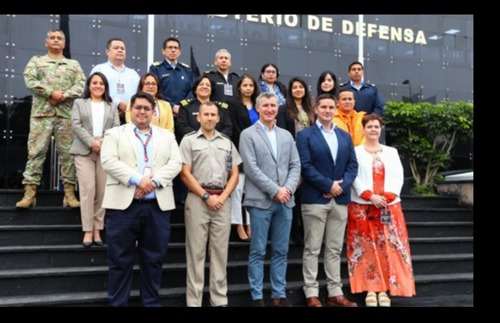 A group of BUIK and course trainers stood on steps outside Peruvian defence staff college. 
