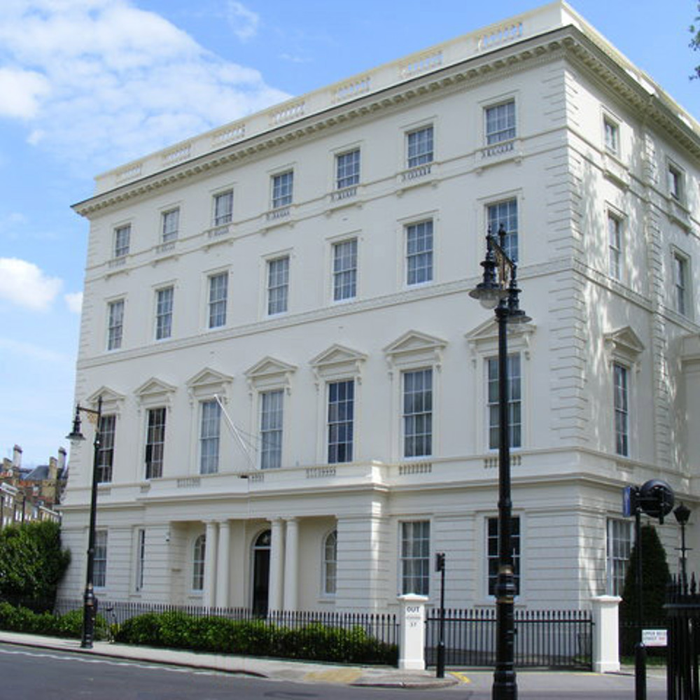 A white building with multiple small glass pane windows.