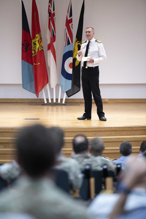 Admiral Sir Tony Radakin on stage presenting to ACSC 26 course members.