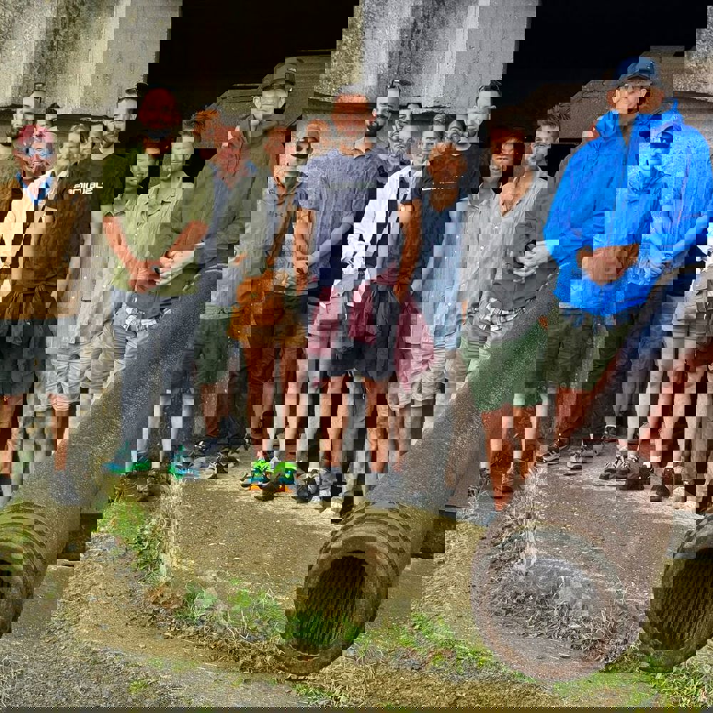A group of people stood next to a large historic canon.