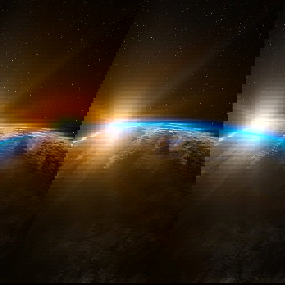 A view of earth from space with the sun being eclipsed in the background. 