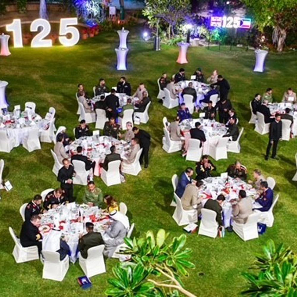 An outside floor plan with round dining tables on grass.