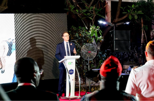 A man in a suit stood behind a lectern addressing a delegation in Nigeria. 