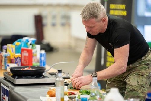Commando chef cooking inside a hall.