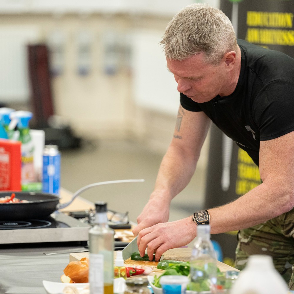 Commando chef cooking inside a hall.